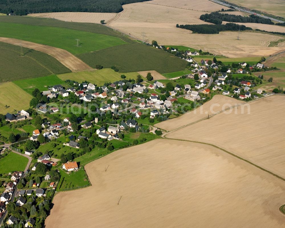 Irbersdorf from the bird's eye view: Agricultural land and field boundaries surround the settlement area of the village in Irbersdorf in the state Saxony, Germany