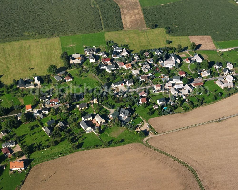 Irbersdorf from the bird's eye view: Agricultural land and field boundaries surround the settlement area of the village in Irbersdorf in the state Saxony, Germany