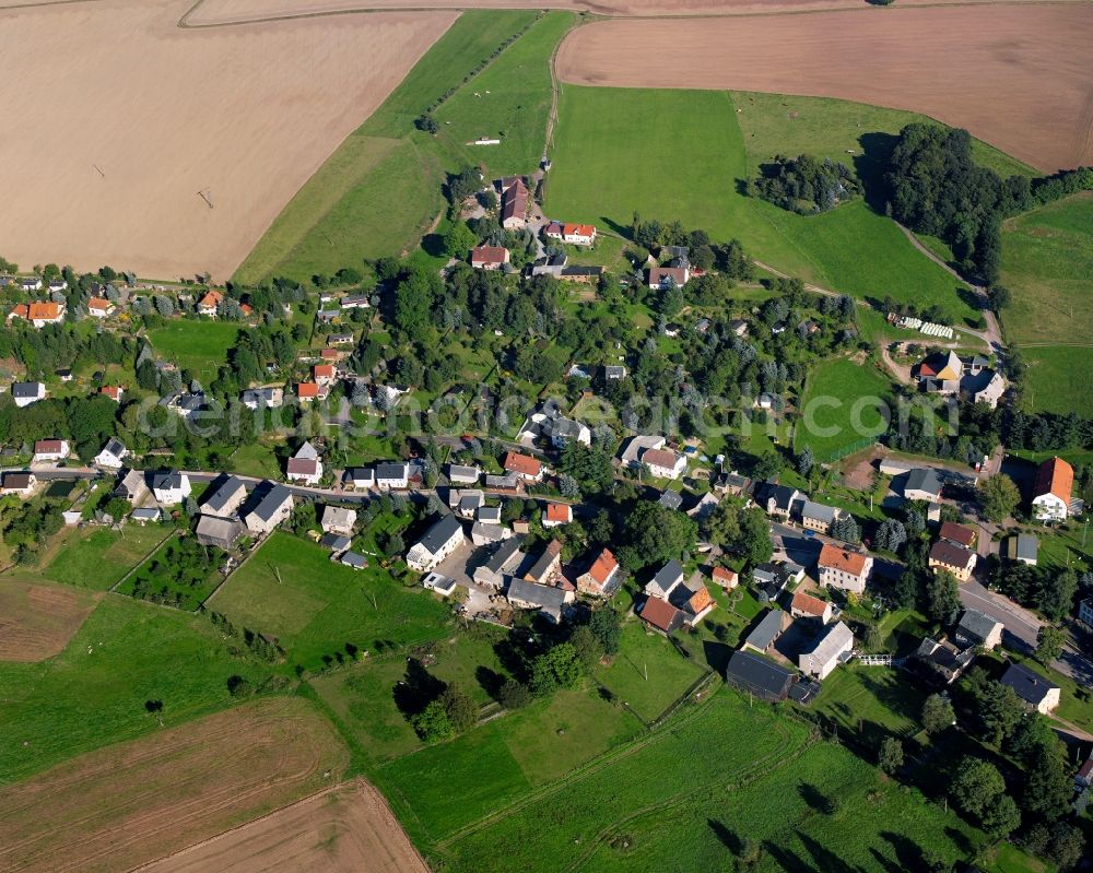 Irbersdorf from above - Agricultural land and field boundaries surround the settlement area of the village in Irbersdorf in the state Saxony, Germany