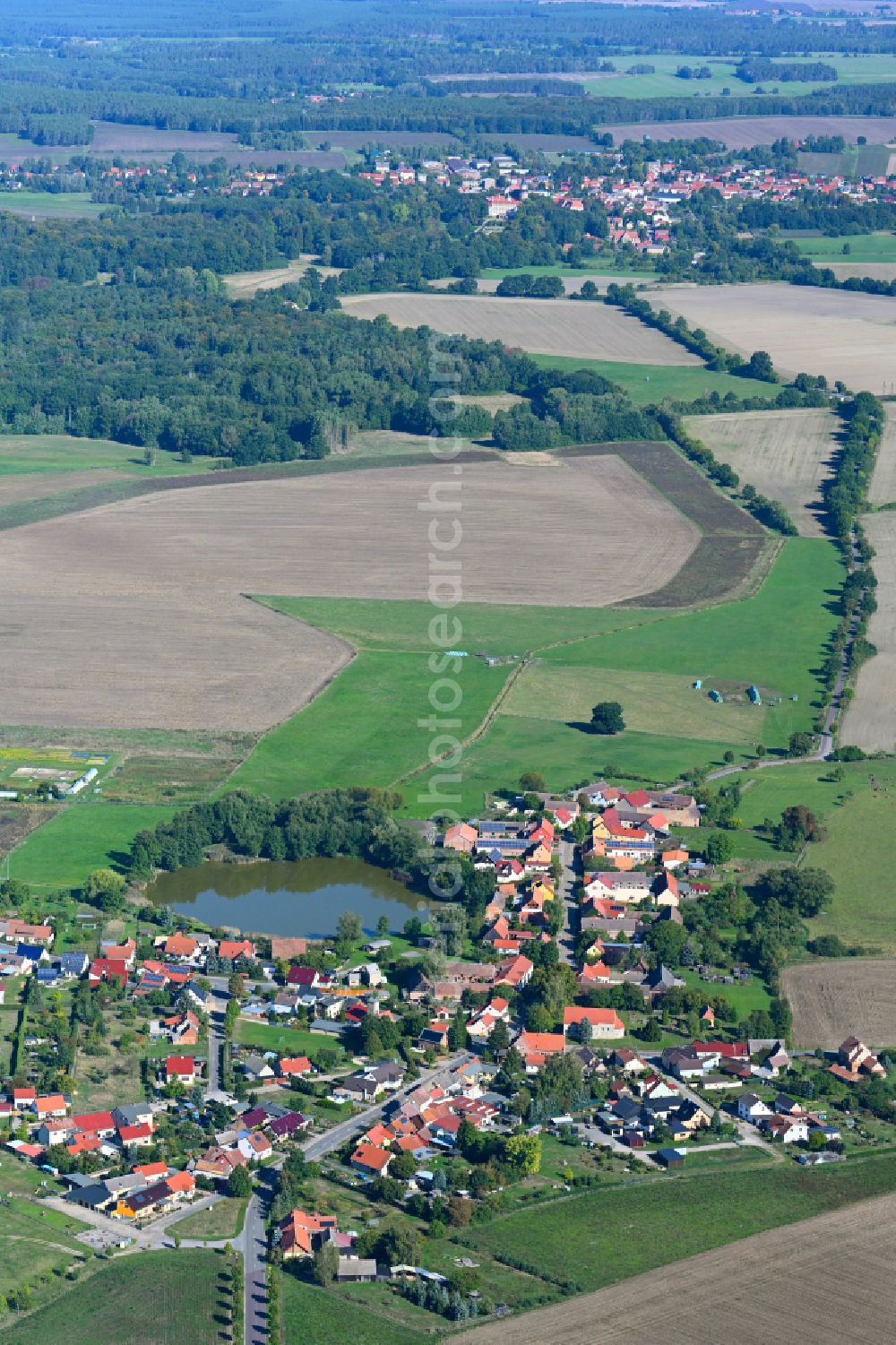 Jeserig/Fläming from the bird's eye view: Agricultural land and field boundaries surround the settlement area of the village in Jeserig/Flaeming in the state Brandenburg, Germany