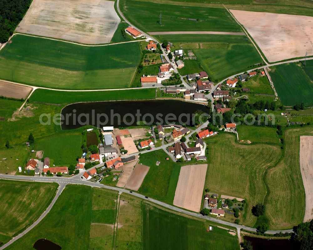 Kaierberg from above - Agricultural land and field boundaries surround the settlement area of the village in Kaierberg in the state Bavaria, Germany