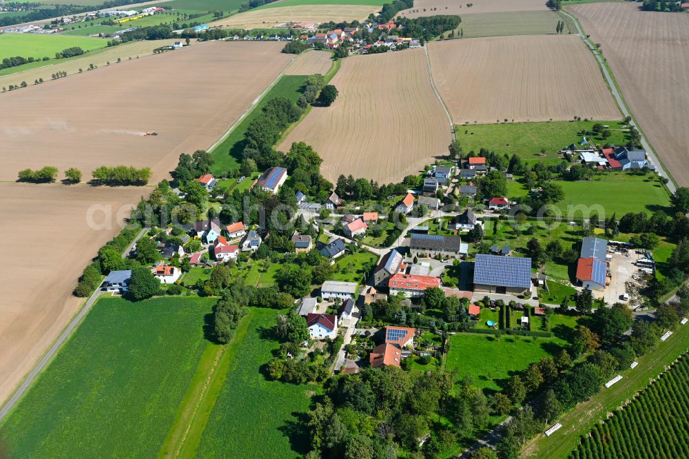 Kertschütz from above - Agricultural land and field boundaries surround the settlement area of the village in Kertschütz in the state Thuringia, Germany