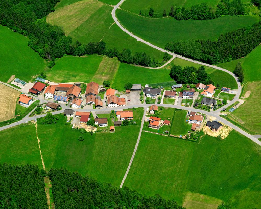 Kühn from above - Agricultural land and field boundaries surround the settlement area of the village in Kühn in the state Bavaria, Germany
