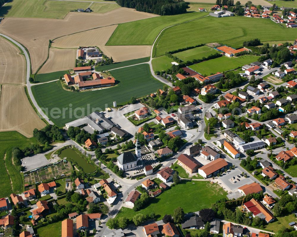 Kirchweidach from above - Agricultural land and field boundaries surround the settlement area of the village in Kirchweidach in the state Bavaria, Germany