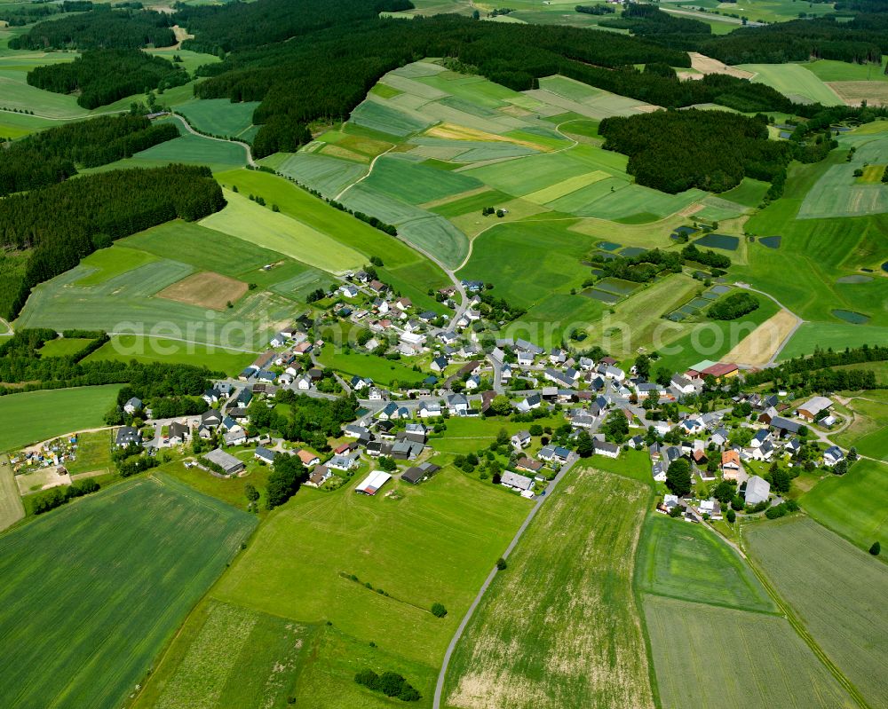 Aerial image Kleinschwarzenbach - Agricultural land and field boundaries surround the settlement area of the village in Kleinschwarzenbach in the state Bavaria, Germany