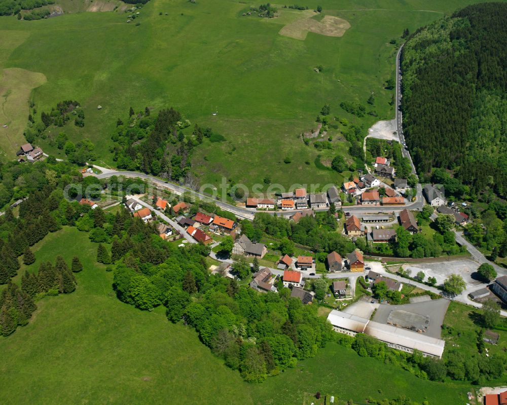 Königshütte (Harz) from above - Agricultural land and field boundaries surround the settlement area of the village in Königshütte (Harz) in the state Saxony-Anhalt, Germany