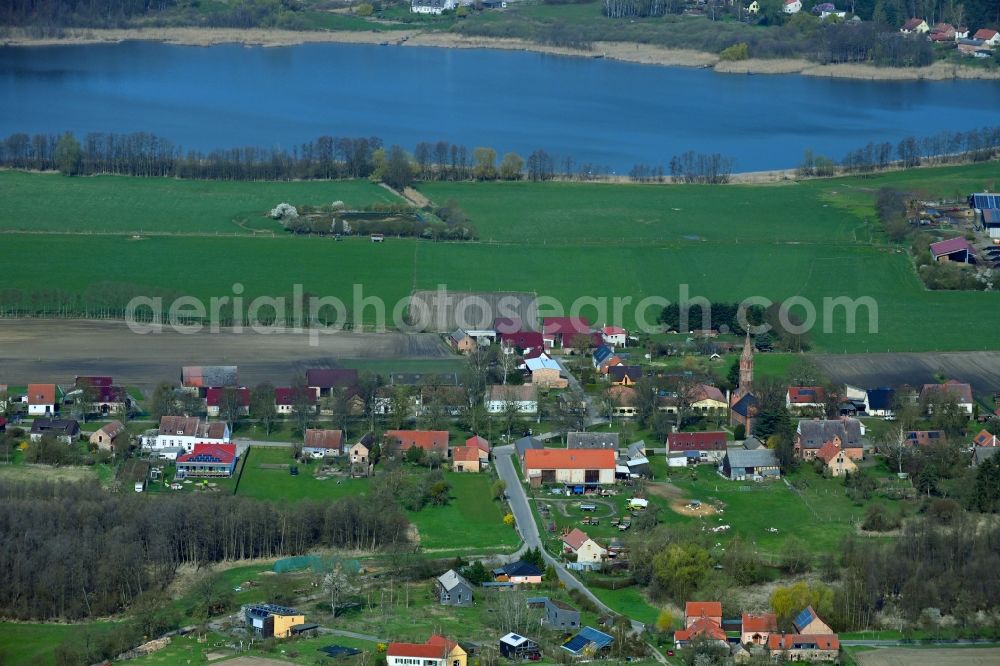 Brodowin from the bird's eye view: Agricultural land and field boundaries surround the settlement area of the village vom Oekodorf Brodowin in the state Brandenburg, Germany