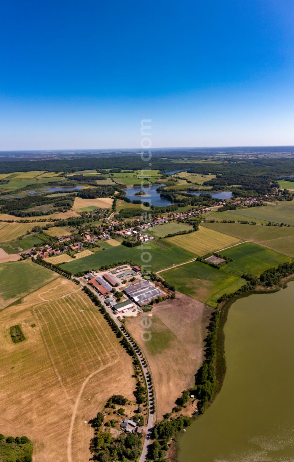 Aerial image Brodowin - Agricultural land and field boundaries surround the settlement area of the village vom Oekodorf Brodowin in the state Brandenburg, Germany