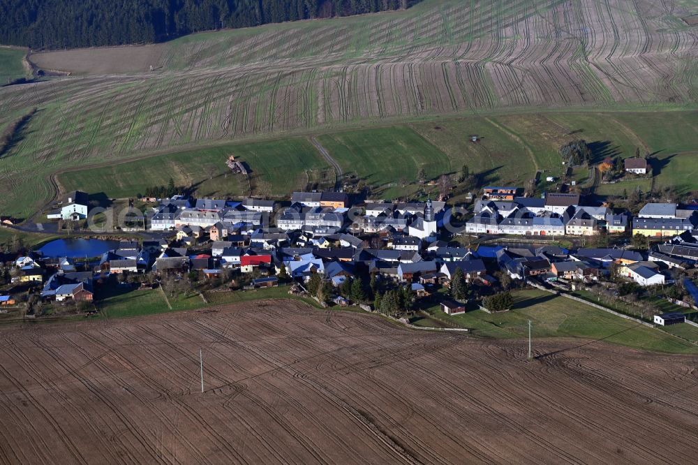 Kolba from above - Agricultural land and field boundaries surround the settlement area of the village in Kolba in the state Thuringia, Germany