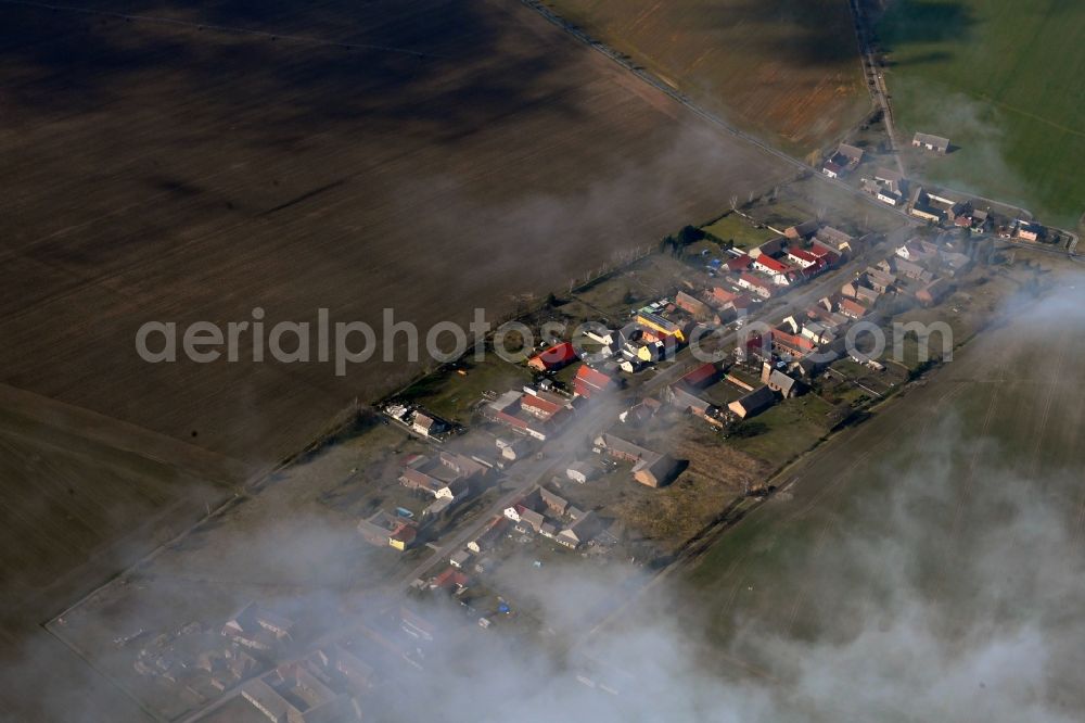 Körbitz from the bird's eye view: Agricultural land and field boundaries surround the settlement area of the village in Koerbitz in the state Brandenburg, Germany