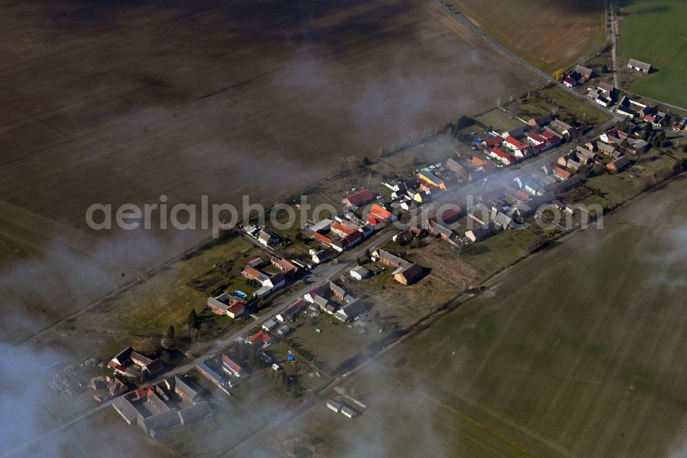 Aerial image Körbitz - Agricultural land and field boundaries surround the settlement area of the village in Koerbitz in the state Brandenburg, Germany