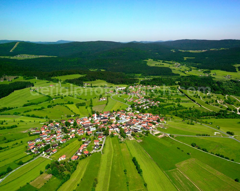 Kreuzberg from the bird's eye view: Agricultural land and field boundaries surround the settlement area of the village in Kreuzberg in the state Bavaria, Germany