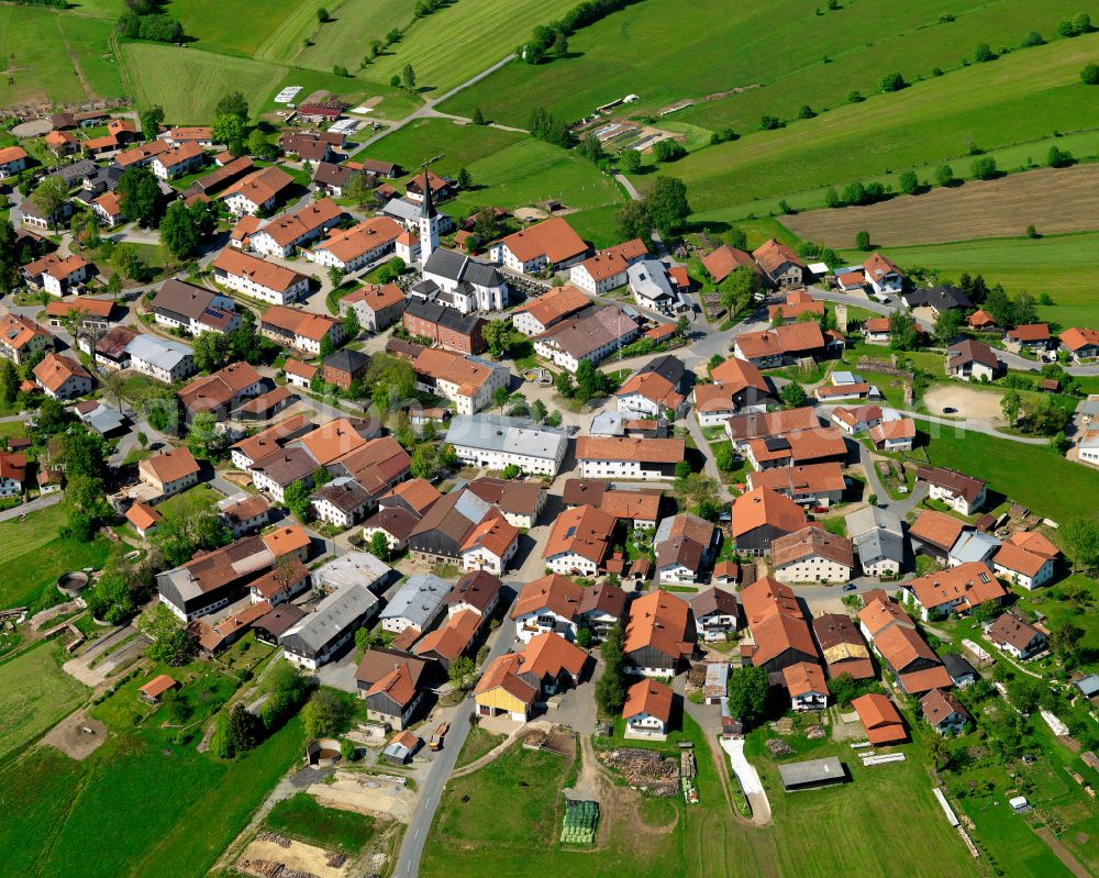 Kreuzberg from above - Agricultural land and field boundaries surround the settlement area of the village in Kreuzberg in the state Bavaria, Germany