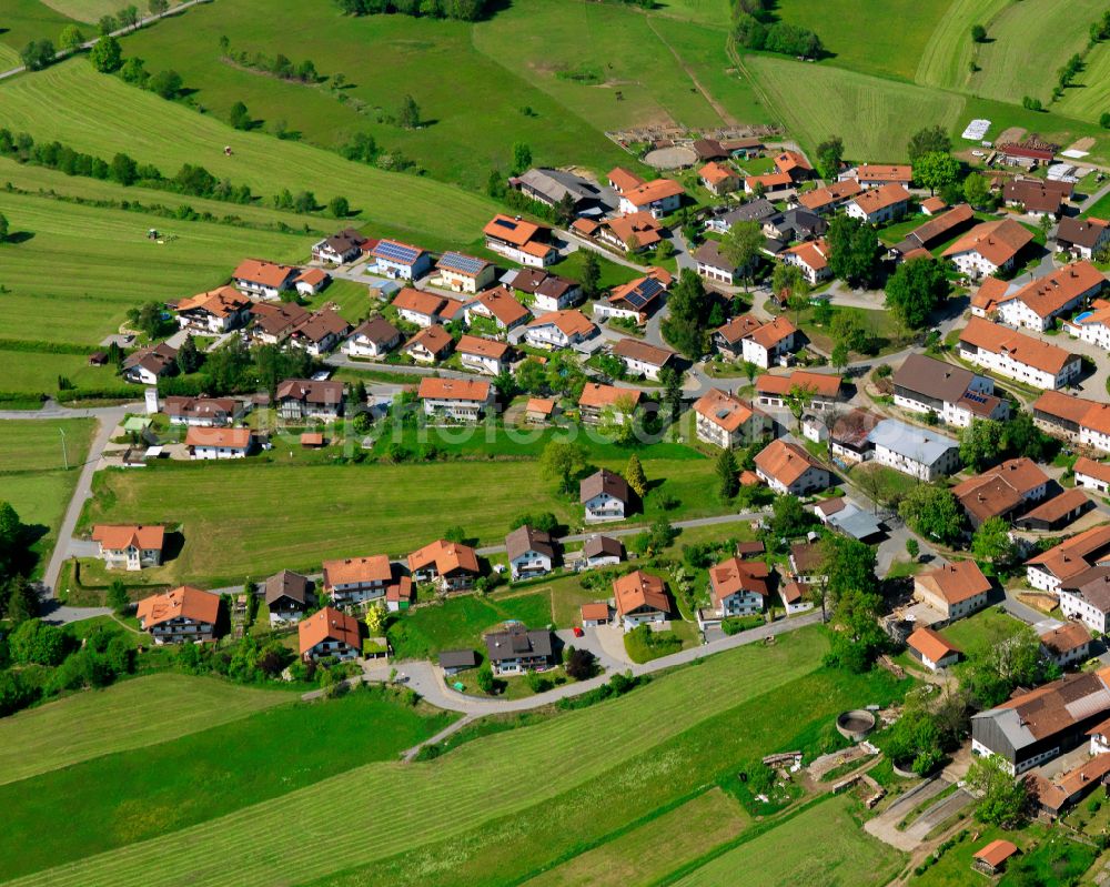 Kreuzberg from the bird's eye view: Agricultural land and field boundaries surround the settlement area of the village in Kreuzberg in the state Bavaria, Germany