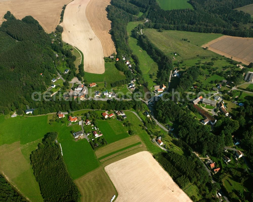 Krummenhennersdorf from the bird's eye view: Agricultural land and field boundaries surround the settlement area of the village in Krummenhennersdorf in the state Saxony, Germany