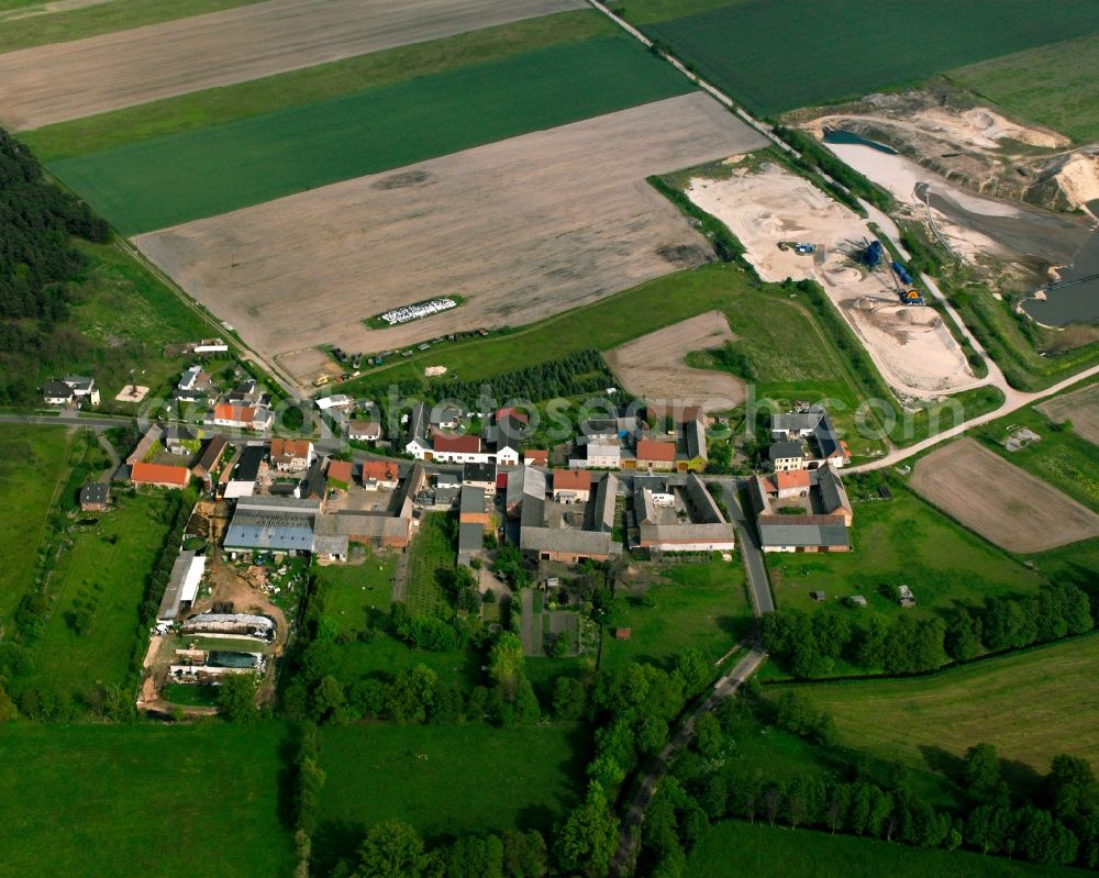 Kuhberge from above - Agricultural land and field boundaries surround the settlement area of the village in Kuhberge in the state Saxony-Anhalt, Germany