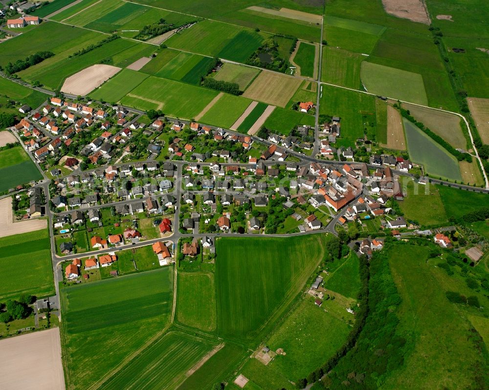 Leimbach from above - Agricultural land and field boundaries surround the settlement area of the village in Leimbach in the state Hesse, Germany