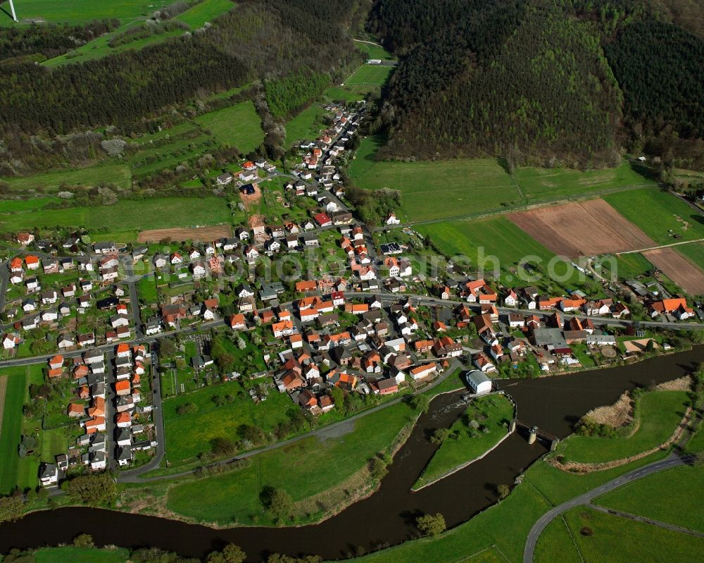 Lengers from above - Agricultural land and field boundaries surround the settlement area of the village in Lengers in the state Hesse, Germany