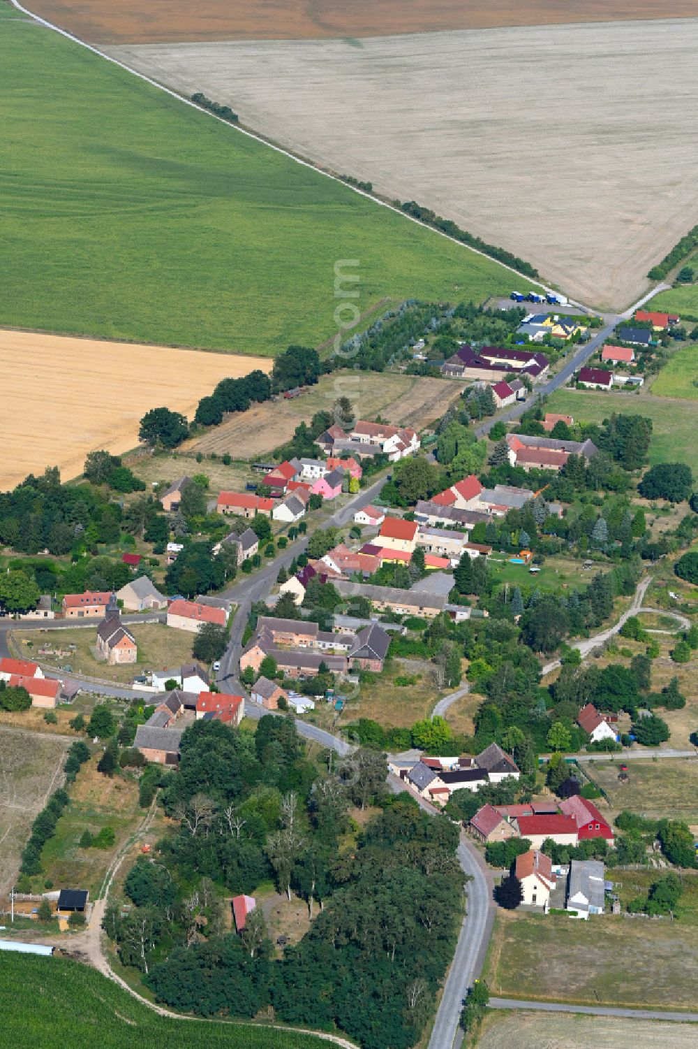 Aerial photograph Lindow - Agricultural land and field boundaries surround the settlement area of the village in Lindow in the state Brandenburg, Germany