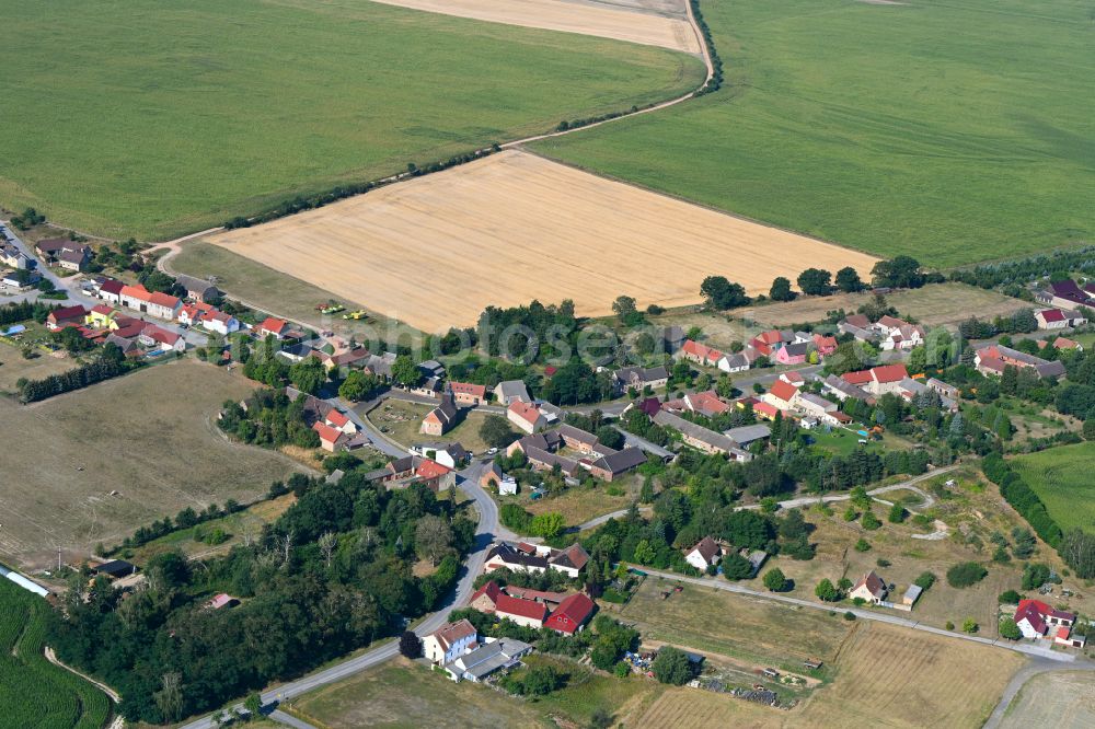 Lindow from above - Agricultural land and field boundaries surround the settlement area of the village in Lindow in the state Brandenburg, Germany
