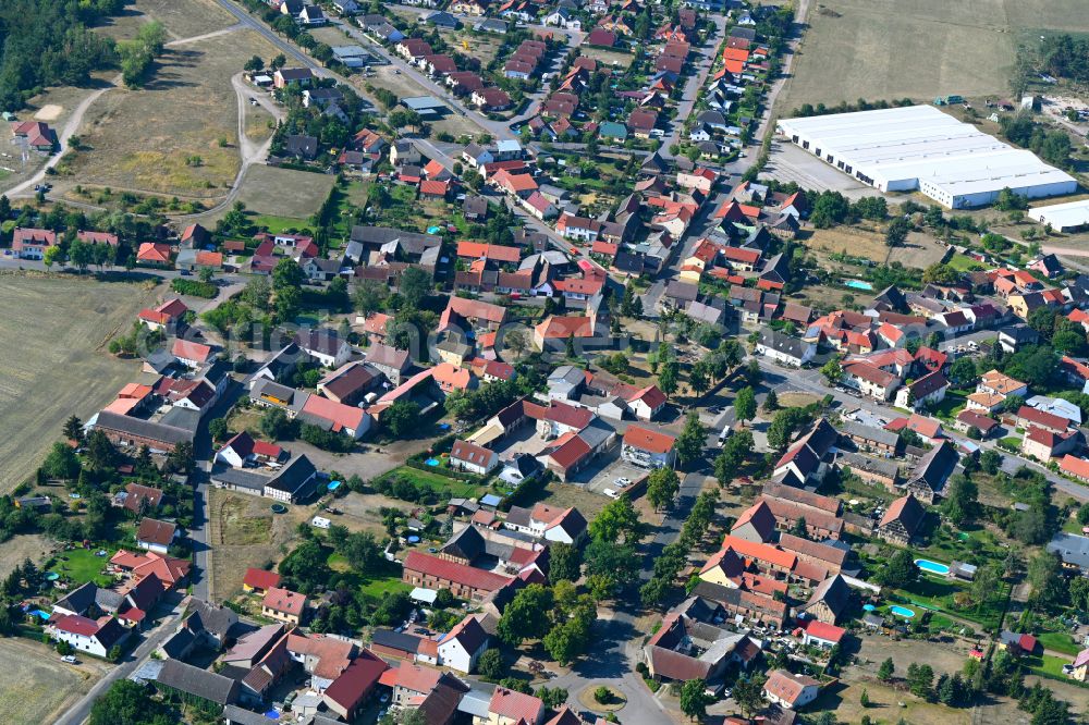 Linthe from above - Agricultural land and field boundaries surround the settlement area of the village in Linthe in the state Brandenburg, Germany