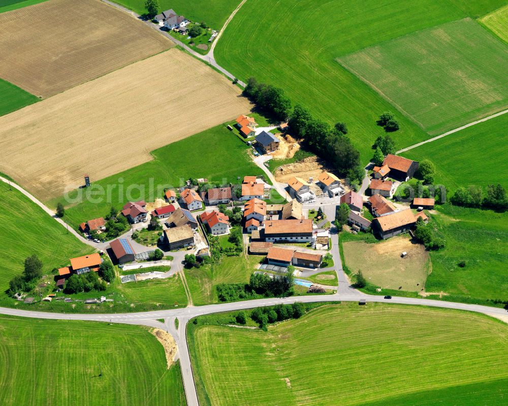 Manzing from above - Agricultural land and field boundaries surround the settlement area of the village in Manzing in the state Bavaria, Germany