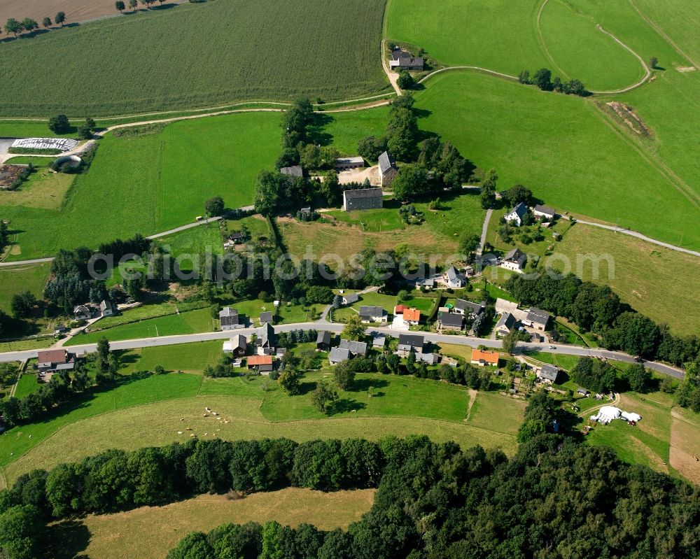 Müdisdorf from above - Agricultural land and field boundaries surround the settlement area of the village in Müdisdorf in the state Saxony, Germany
