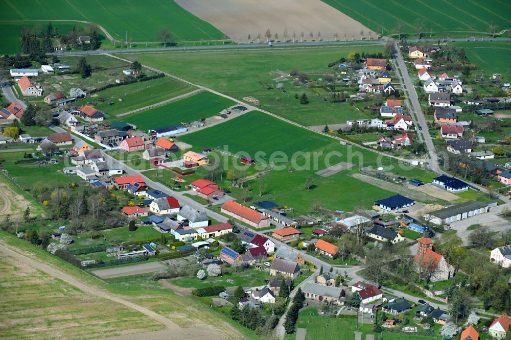 Menkin from above - Agricultural land and field boundaries surround the settlement area of the village in Menkin in the state Brandenburg, Germany