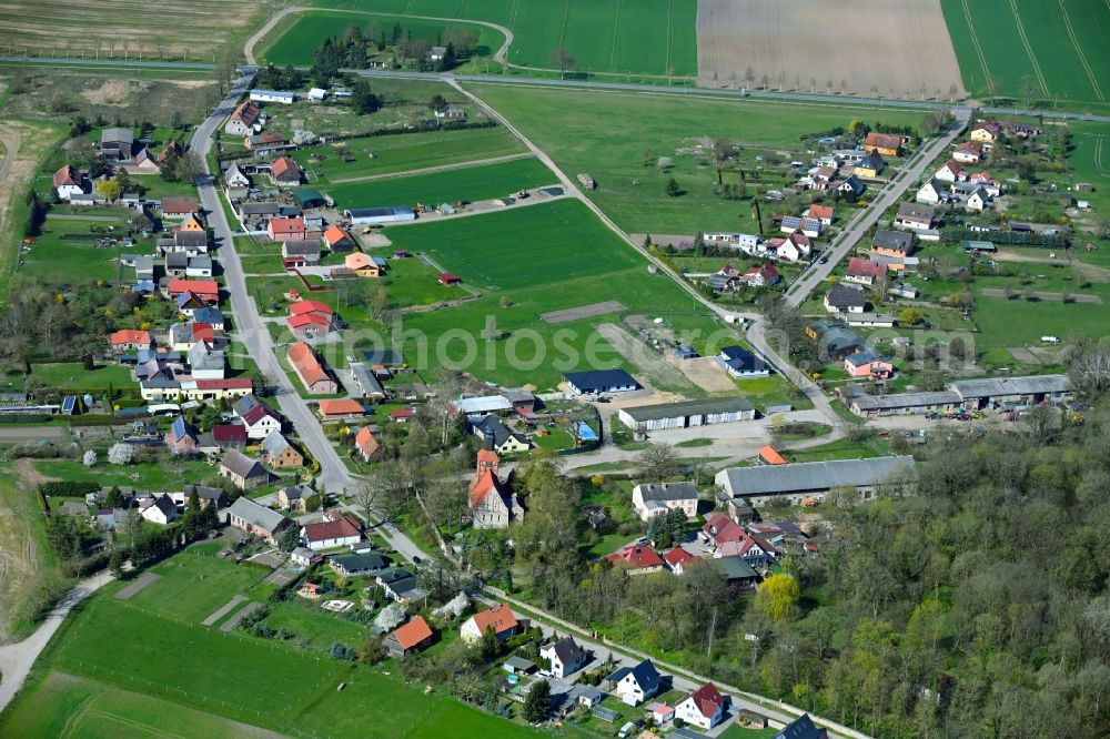 Menkin from the bird's eye view: Agricultural land and field boundaries surround the settlement area of the village in Menkin in the state Brandenburg, Germany
