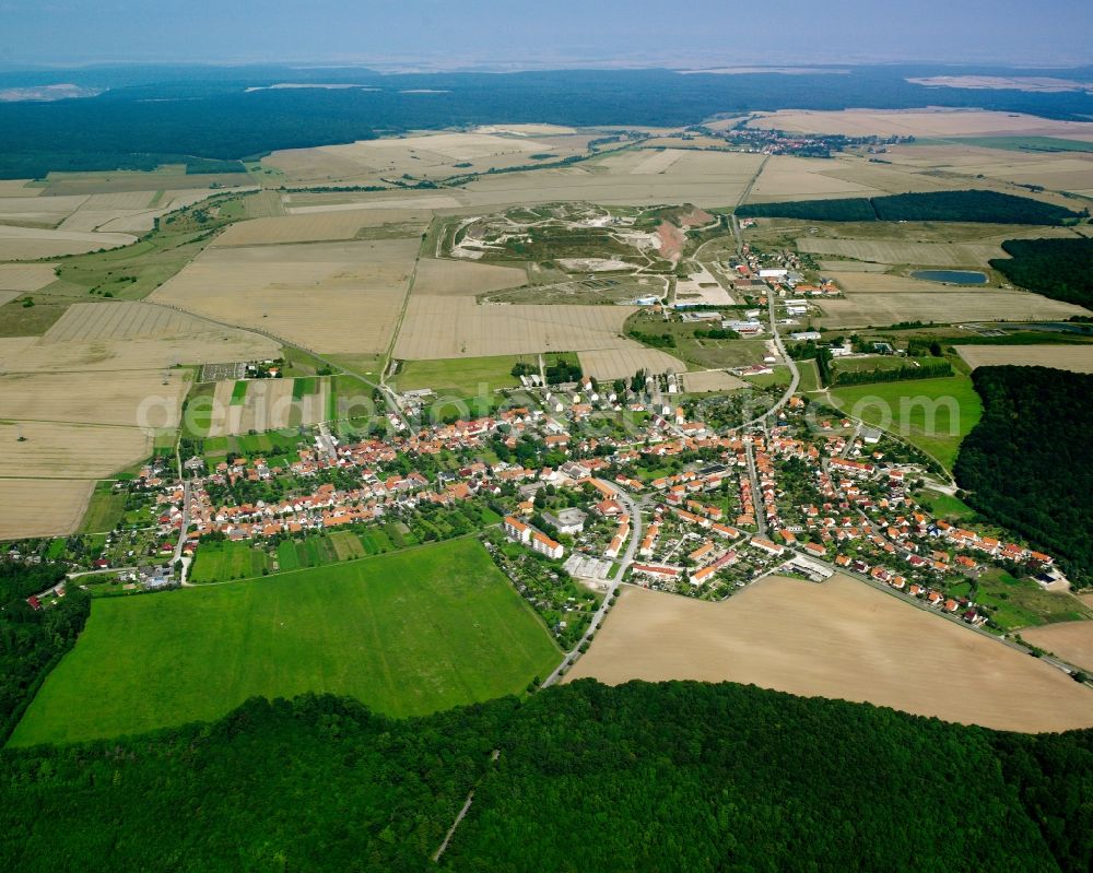 Menteroda from above - Agricultural land and field boundaries surround the settlement area of the village in Menteroda in the state Thuringia, Germany