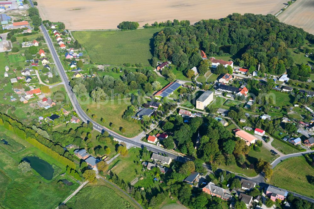 Mildenitz from the bird's eye view: Agricultural land and field boundaries surround the settlement area of the village on street Schlossstrasse in Mildenitz in the state Mecklenburg - Western Pomerania, Germany