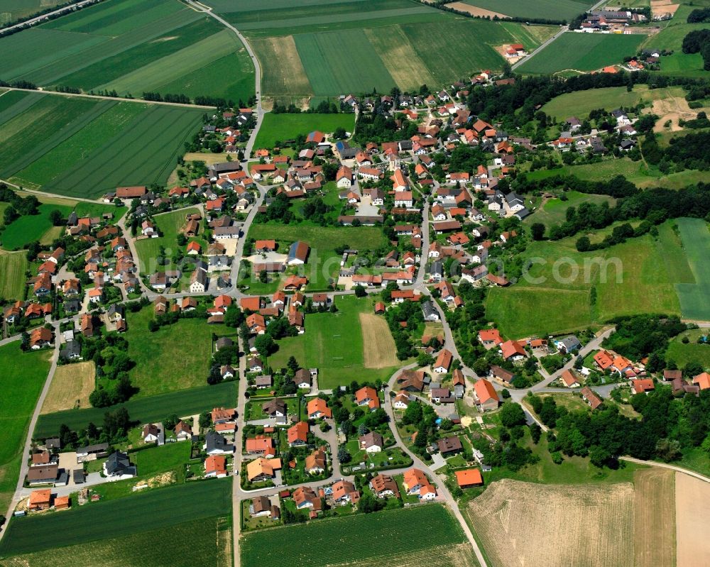 Münster from above - Agricultural land and field boundaries surround the settlement area of the village in Münster in the state Bavaria, Germany