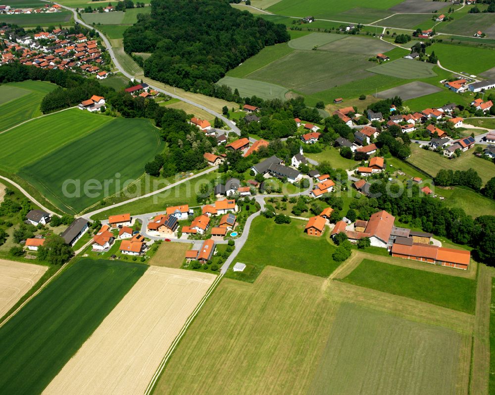 Mörmoosen from above - Agricultural land and field boundaries surround the settlement area of the village in Mörmoosen in the state Bavaria, Germany
