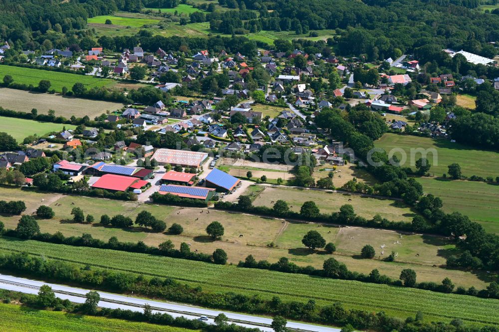 Aerial photograph Negernbötel - Agricultural land and field boundaries surround the settlement area of the village in Negernboetel in the state Schleswig-Holstein, Germany