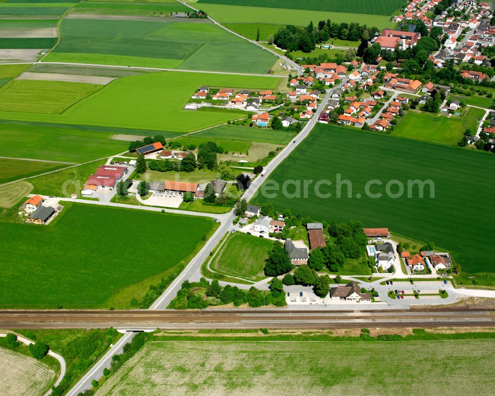 Neue Heimat from above - Agricultural land and field boundaries surround the settlement area of the village in Neue Heimat in the state Bavaria, Germany