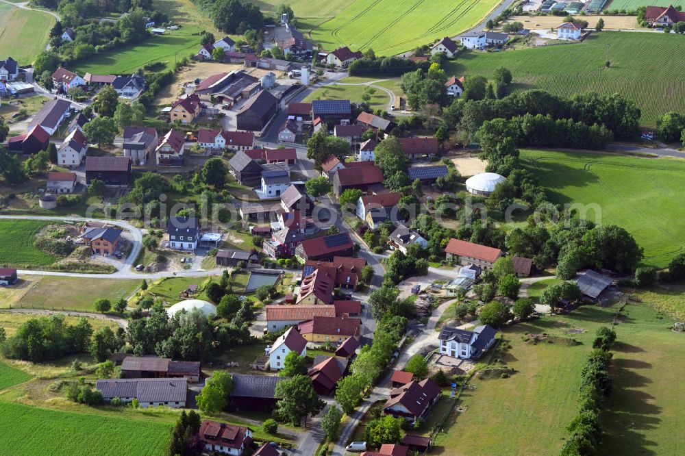 Neuhof from the bird's eye view: Agricultural land and field boundaries surround the settlement area of the village in Neuhof in the state Bavaria, Germany