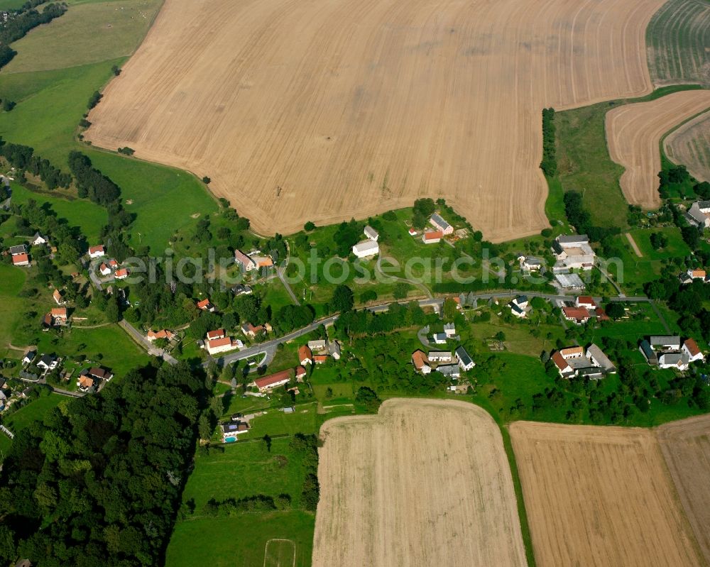 Neukirchen from the bird's eye view: Agricultural land and field boundaries surround the settlement area of the village in Neukirchen in the state Saxony, Germany