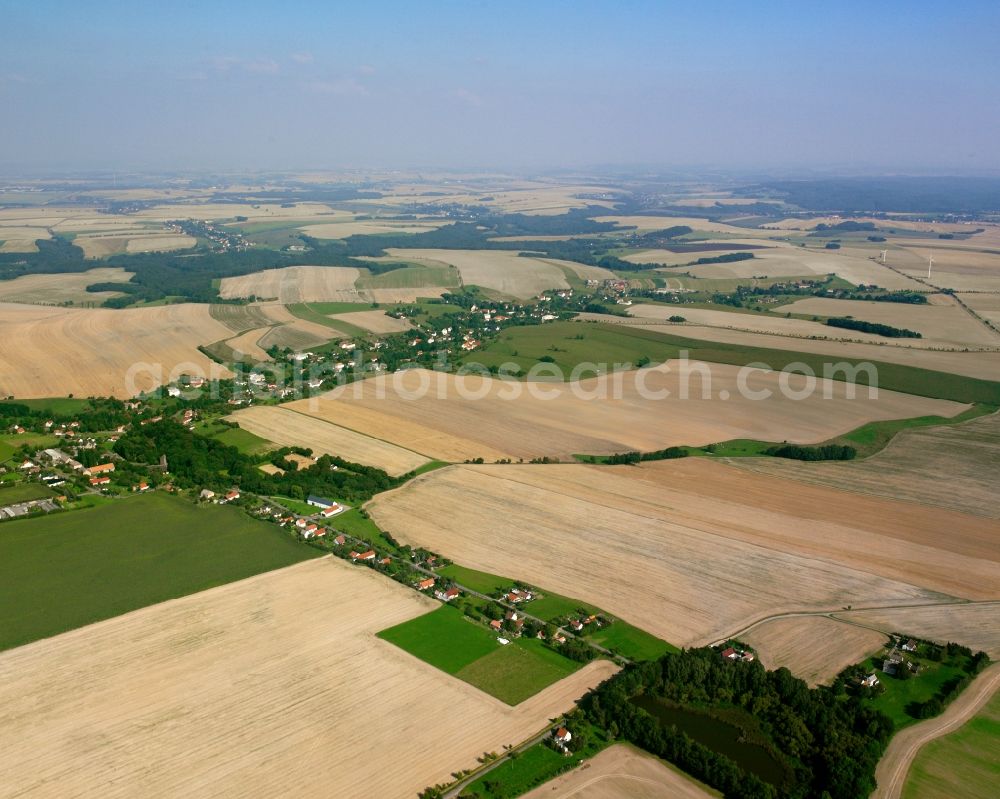 Neukirchen from the bird's eye view: Agricultural land and field boundaries surround the settlement area of the village in Neukirchen in the state Saxony, Germany