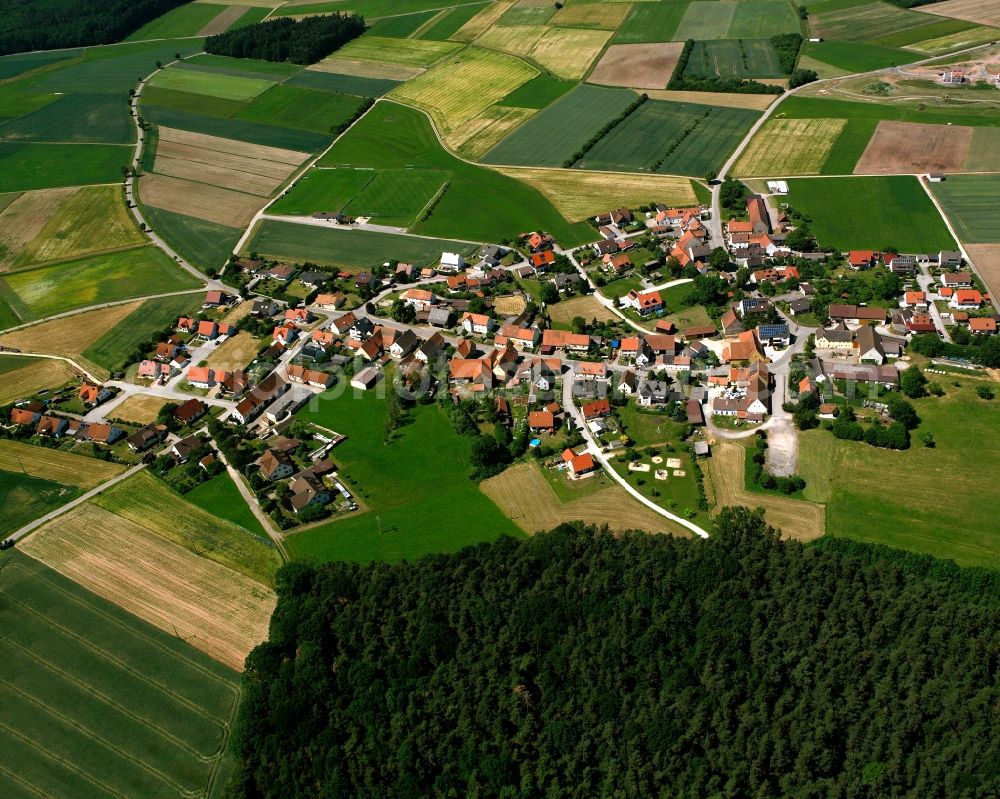 Neuses from above - Agricultural land and field boundaries surround the settlement area of the village in Neuses in the state Bavaria, Germany