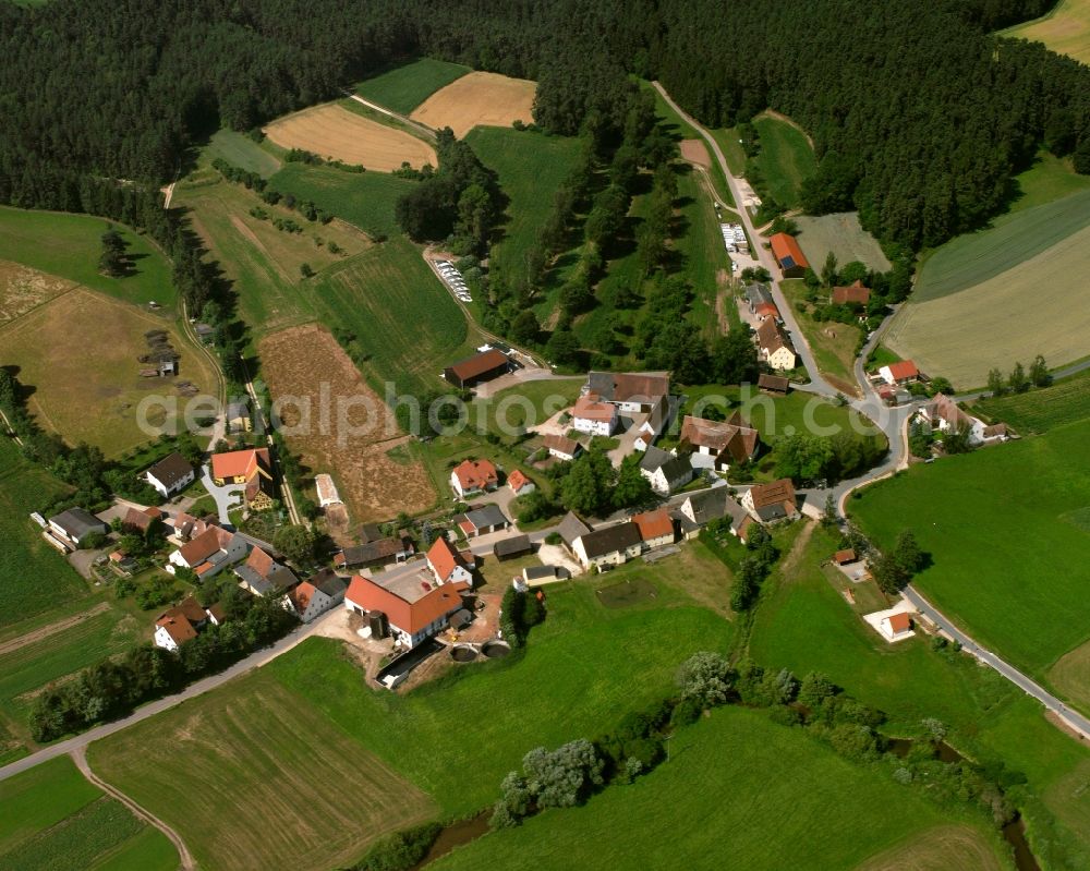Aerial image Neuses - Agricultural land and field boundaries surround the settlement area of the village in Neuses in the state Bavaria, Germany