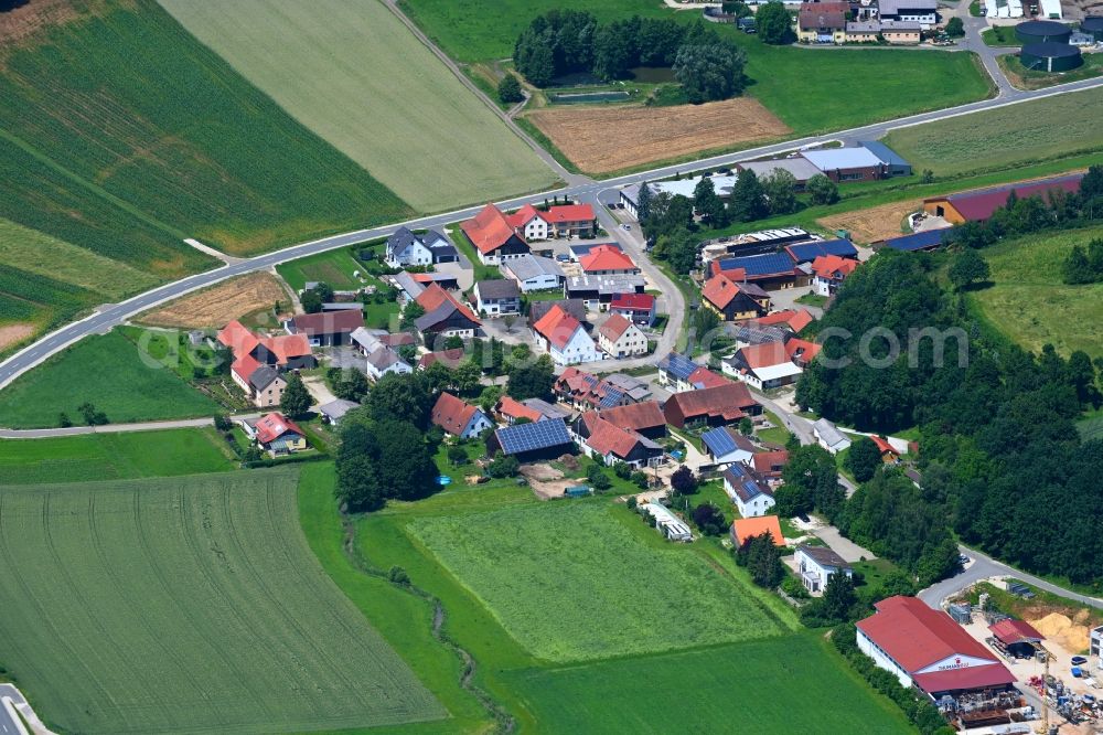 Niederhofen from the bird's eye view: Agricultural land and field boundaries surround the settlement area of the village in Niederhofen in the state Bavaria, Germany