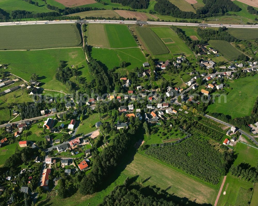 Niederlichtenau from above - Agricultural land and field boundaries surround the settlement area of the village in Niederlichtenau in the state Saxony, Germany