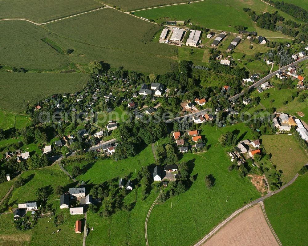 Niederlichtenau from the bird's eye view: Agricultural land and field boundaries surround the settlement area of the village in Niederlichtenau in the state Saxony, Germany