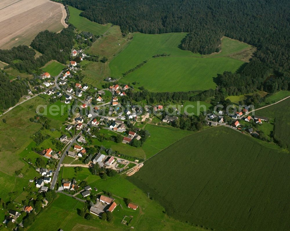 Niederschöna from above - Agricultural land and field boundaries surround the settlement area of the village in Niederschöna in the state Saxony, Germany