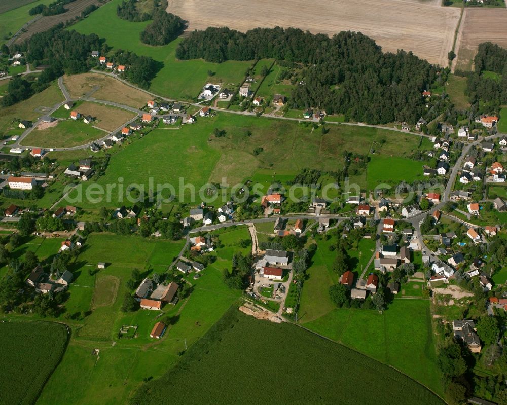 Niederschöna from the bird's eye view: Agricultural land and field boundaries surround the settlement area of the village in Niederschöna in the state Saxony, Germany