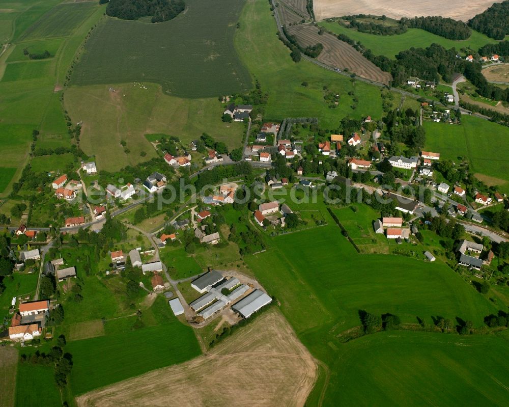 Niederschöna from the bird's eye view: Agricultural land and field boundaries surround the settlement area of the village in Niederschöna in the state Saxony, Germany