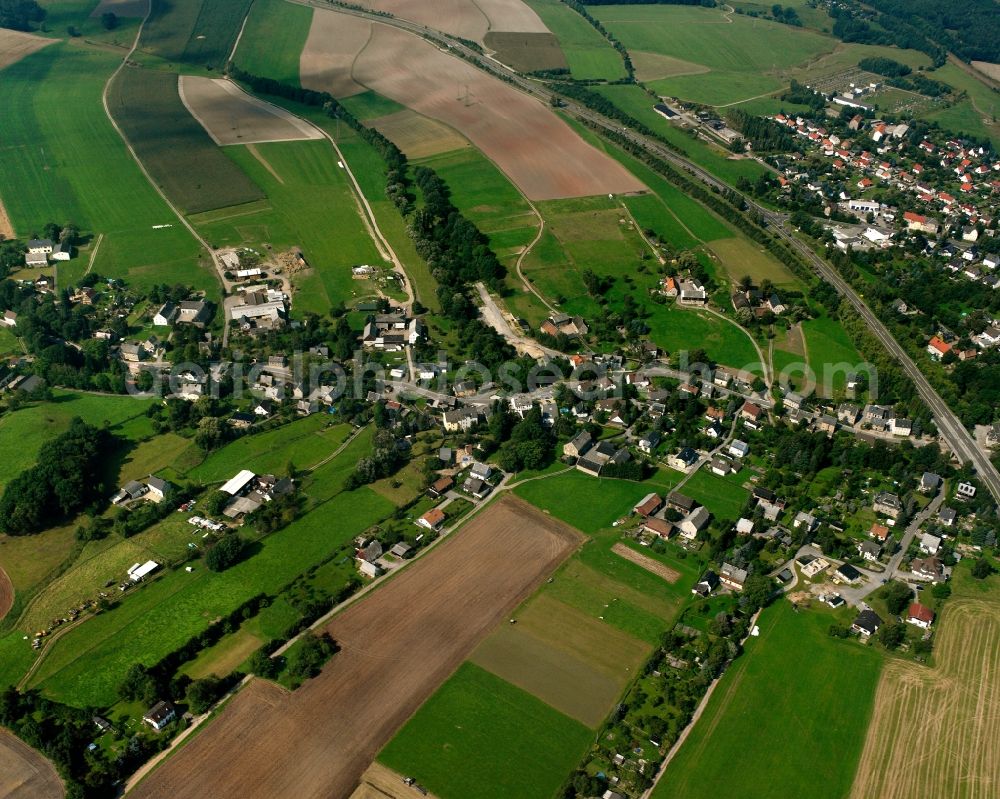 Niederwiesa from the bird's eye view: Agricultural land and field boundaries surround the settlement area of the village in Niederwiesa in the state Saxony, Germany