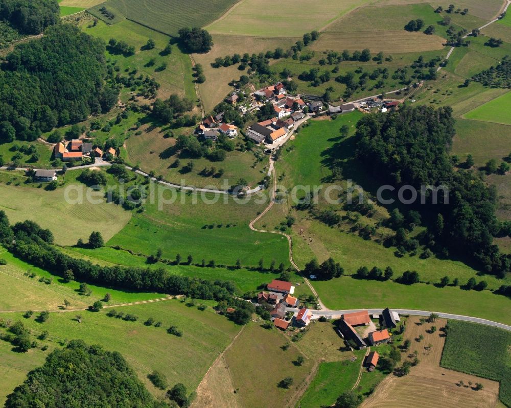 Ober-Ostern from the bird's eye view: Agricultural land and field boundaries surround the settlement area of the village in Ober-Ostern in the state Hesse, Germany