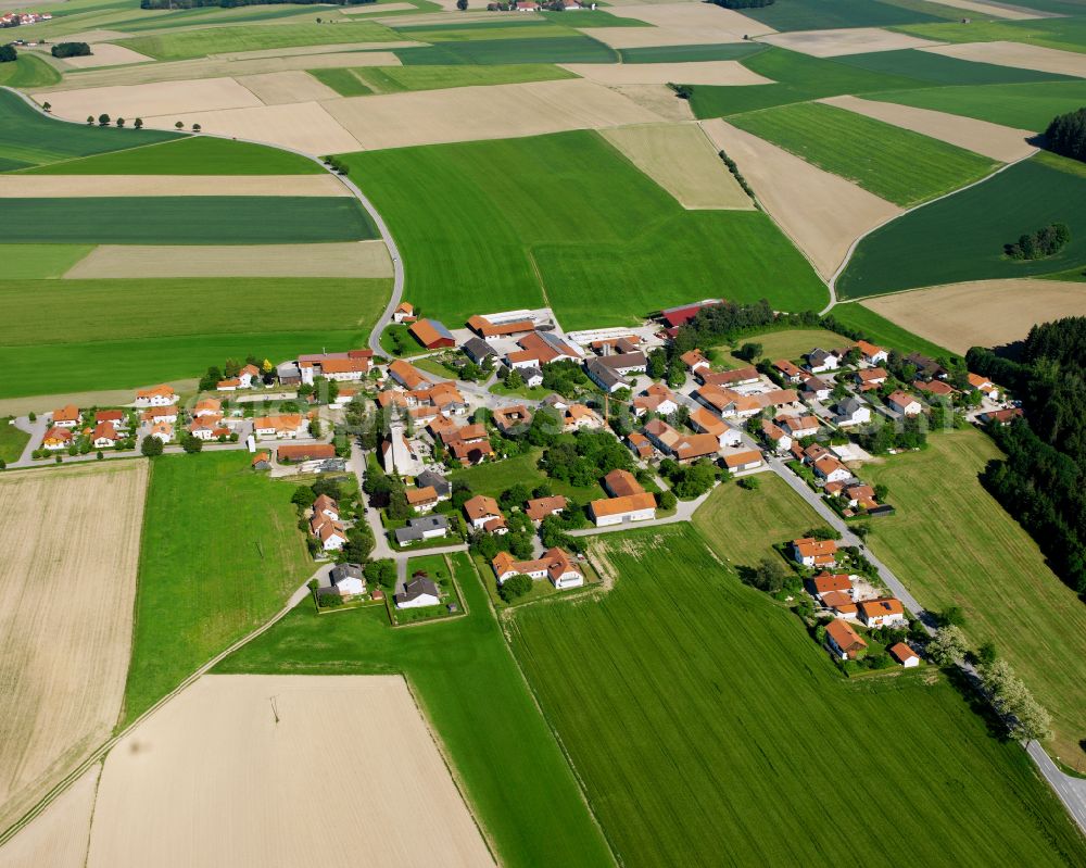 Oberbuch from above - Agricultural land and field boundaries surround the settlement area of the village in Oberbuch in the state Bavaria, Germany