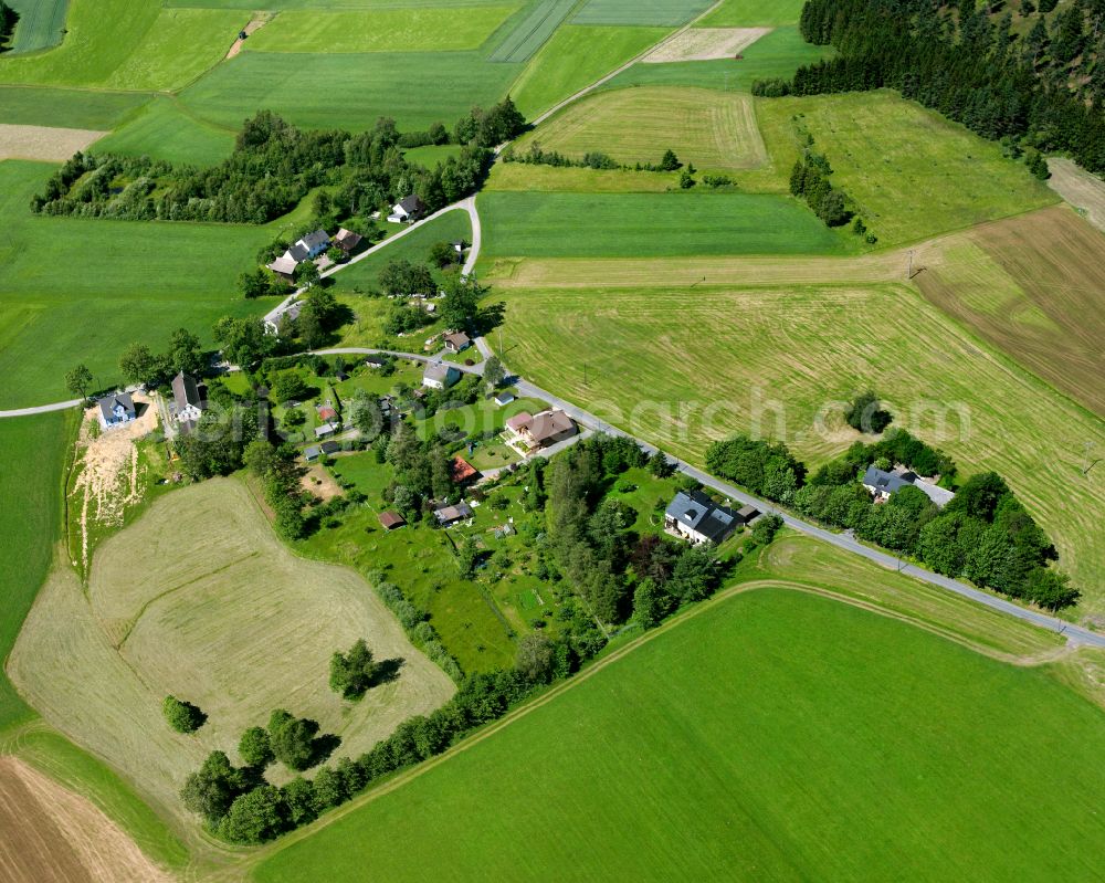 Oberhaid from above - Agricultural land and field boundaries surround the settlement area of the village in Oberhaid in the state Bavaria, Germany